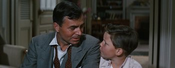 Movie still from “Bigger Than Life” (1956), directed by Nicholas Ray – An older man wearing a suit and tie talking to a young boy wearing a tie; Close Up shot, Over the shoulder angle