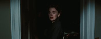 Movie still from “Bigger Than Life” (1956), directed by Nicholas Ray – A woman with red hair wearing a black dress; Close Up shot, Low angle