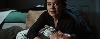 Movie still from “Bigger Than Life” (1956), directed by Nicholas Ray – A woman laying on the ground with a man; Close Up shot, High angle