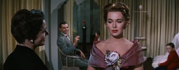 Movie still from “Bigger Than Life” (1956), directed by Nicholas Ray – A man and a woman sitting in front of each other in a room; Close Up shot, Over the shoulder angle