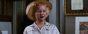 Movie still from “Bigger Than Life” (1956), directed by Nicholas Ray – An older woman wearing a straw hat; Close Up shot, Low angle