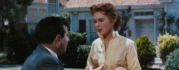 Movie still from “Bigger Than Life” (1956), directed by Nicholas Ray – An older woman talking to a younger man outside of a house; Close Up shot, Over the shoulder angle