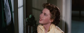 Movie still from “Bigger Than Life” (1956), directed by Nicholas Ray – A woman in a yellow shirt is looking up; Close Up shot, Over the shoulder angle