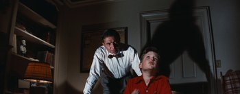Movie still from “Bigger Than Life” (1956), directed by Nicholas Ray – An older man and a young boy in a room; Medium shot, Low angle