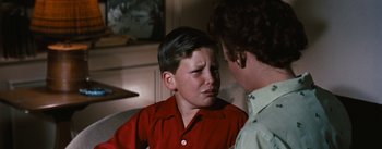 Movie still from “Bigger Than Life” (1956), directed by Nicholas Ray – A young boy crying while talking to his mother; Close Up shot, Over the shoulder angle