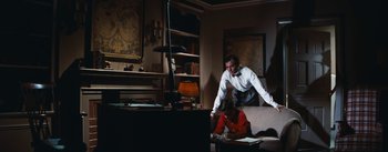 Movie still from “Bigger Than Life” (1956), directed by Nicholas Ray – A man and a woman in a living room; Wide shot, High angle