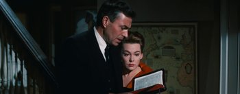 Movie still from “Bigger Than Life” (1956), directed by Nicholas Ray – A man and a woman looking at a book together; Close Up shot, Low angle