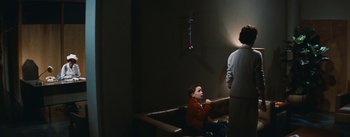 Movie still from “Bigger Than Life” (1956), directed by Nicholas Ray – A boy sitting in a bathtub next to a woman; Wide shot, Over the shoulder angle