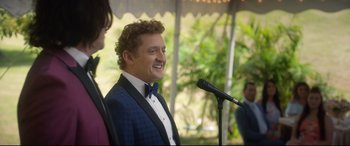 Movie still from “Bill & Ted Face the Music” (2020), directed by Dean Parisot – A man in a blue jacket is talking into a microphone; Close Up shot, Over the shoulder angle