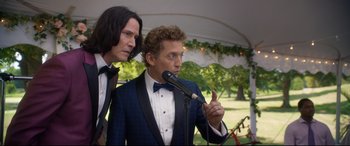 Movie still from “Bill & Ted Face the Music” (2020), directed by Dean Parisot – Two men in tuxedos stand next to each other; Medium shot, Over the shoulder angle