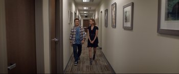 Movie still from “Bill & Ted Face the Music” (2020), directed by Dean Parisot – A man and a woman are walking down a hallway; Wide shot, Over the shoulder angle