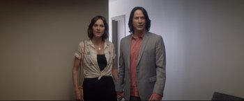 Movie still from “Bill & Ted Face the Music” (2020), directed by Dean Parisot – A man and a woman standing next to each other; Medium shot, Low angle