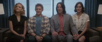 Movie still from “Bill & Ted Face the Music” (2020), directed by Dean Parisot – A couple of men sitting next to each other on a couch; Medium shot, Over the shoulder angle