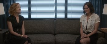 Movie still from “Bill & Ted Face the Music” (2020), directed by Dean Parisot – A brown couch sitting in front of a window with blinds; Wide shot, High angle