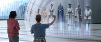 Movie still from “Bill & Ted Face the Music” (2020), directed by Dean Parisot – A man standing in front of a group of people; Wide shot, Over the shoulder angle