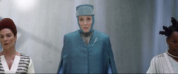 Movie still from “Bill & Ted Face the Music” (2020), directed by Dean Parisot – An older woman wearing a blue suit and a hat; Medium shot, Low angle