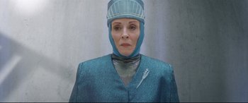 Movie still from “Bill & Ted Face the Music” (2020), directed by Dean Parisot – An older woman wearing a surgical gown and a surgical cap; Close Up shot, Low angle