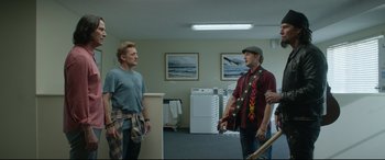 Movie still from “Bill & Ted Face the Music” (2020), directed by Dean Parisot – Two men standing in a room talking to each other; Wide shot, Over the shoulder angle