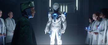 Movie still from “Bill & Ted Face the Music” (2020), directed by Dean Parisot – An image of a man that is wearing a robot suit; Medium shot, Over the shoulder angle