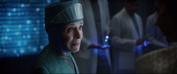 Movie still from “Bill & Ted Face the Music” (2020), directed by Dean Parisot – An older woman wearing a blue hat and a blue robe; Close Up shot, Over the shoulder angle