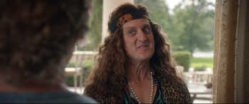 Movie still from “Bill & Ted Face the Music” (2020), directed by Dean Parisot – A man with long curly hair wearing a head scarf; Close Up shot, Over the shoulder angle