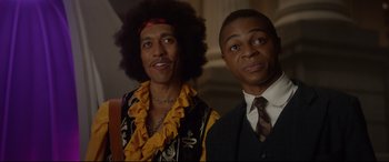 Movie still from “Bill & Ted Face the Music” (2020), directed by Dean Parisot – Two men standing next to each other in front of a wall; Close Up shot, Low angle