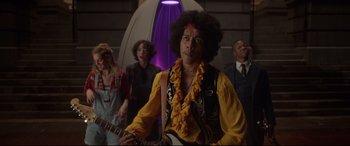 Movie still from “Bill & Ted Face the Music” (2020), directed by Dean Parisot – A group of people standing in a room; Medium shot, Low angle