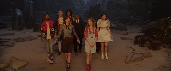 Movie still from “Bill & Ted Face the Music” (2020), directed by Dean Parisot – A group of people standing in front of a rock wall; Wide shot, High angle