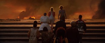 Movie still from “Bill & Ted Face the Music” (2020), directed by Dean Parisot – A group of people standing on steps near a fire; Wide shot, High angle