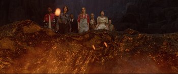 Movie still from “Bill & Ted Face the Music” (2020), directed by Dean Parisot – A group of people standing in front of an erupting volcano; Wide shot, Low angle