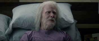 Movie still from “Bill & Ted Face the Music” (2020), directed by Dean Parisot – An old man with white hair laying in a bed; Close Up shot, Over the shoulder angle