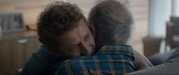 Movie still from “Bill & Ted Face the Music” (2020), directed by Dean Parisot – A man hugging another man with his arms around another man; Close Up shot, Over the shoulder angle