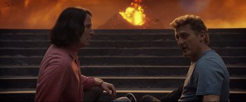 Movie still from “Bill & Ted Face the Music” (2020), directed by Dean Parisot – A man sitting on top of a chair next to another man; Medium shot, Over the shoulder angle