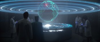 Movie still from “Bill & Ted Face the Music” (2020), directed by Dean Parisot – A man standing in front of a globe in a room; Extreme Wide shot, Over the shoulder angle