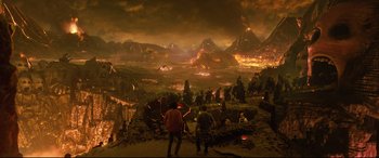 Movie still from “Bill & Ted Face the Music” (2020), directed by Dean Parisot – A group of people standing in front of an erupting volcano; Extreme Wide shot, High angle