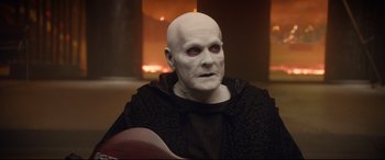 Movie still from “Bill & Ted Face the Music” (2020), directed by Dean Parisot – A man with a bald head wearing a white mask; Medium shot, Over the shoulder angle
