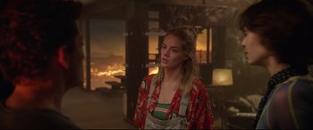 Movie still from “Bill & Ted Face the Music” (2020), directed by Dean Parisot – A woman standing in front of a burning building; Medium shot, Over the shoulder angle