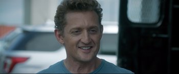 Movie still from “Bill & Ted Face the Music” (2020), directed by Dean Parisot – A person with curly hair smiling; Close Up shot, Over the shoulder angle