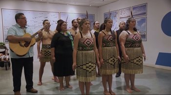 Movie still from “Billie Eilish: The World's a Little Blurry” (2021), directed by R.J. Cutler – A group of men and women standing next to each other; Wide shot, High angle