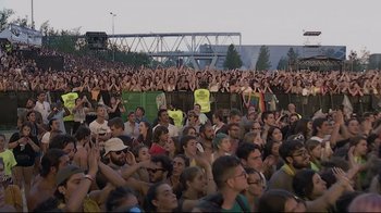 Movie still from “Billie Eilish: The World's a Little Blurry” (2021), directed by R.J. Cutler – A crowd of people sitting in front of an audience; Extreme Wide shot, High angle
