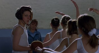 Movie still from “Billy Elliot” (2000), directed by Stephen Daldry – A group of young people in white shirts playing a game of ping pong; Close Up shot, Over the shoulder angle