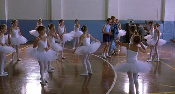 Movie still from “Billy Elliot” (2000), directed by Stephen Daldry – A group of young ballerinas in white tutus; Wide shot, High angle