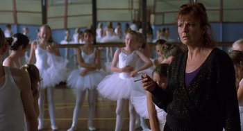 Movie still from “Billy Elliot” (2000), directed by Stephen Daldry – A group of young ballerinas and their teacher; Medium shot, Over the shoulder angle
