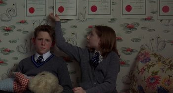 Movie still from “Billy Elliot” (2000), directed by Stephen Daldry – A boy and a girl in school uniforms playing a game; Medium shot, Low angle