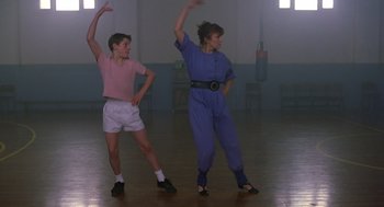 Movie still from “Billy Elliot” (2000), directed by Stephen Daldry – Two young people are dancing in a gymnasium; Wide shot, Low angle