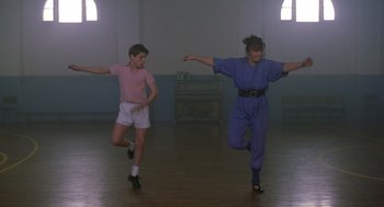 Movie still from “Billy Elliot” (2000), directed by Stephen Daldry – A couple of people that are dancing in a room; Wide shot, Low angle