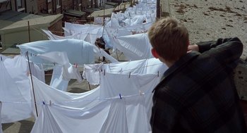 Movie still from “Billy Elliot” (2000), directed by Stephen Daldry – Many white sheets hanging on a line; Wide shot, High angle