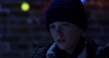 Movie still from “Billy Elliot” (2000), directed by Stephen Daldry – A young boy wearing a hat and a scarf; Close Up shot, Low angle