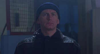 Movie still from “Billy Elliot” (2000), directed by Stephen Daldry – A man wearing a black jacket and a blue hat; Close Up shot, Low angle