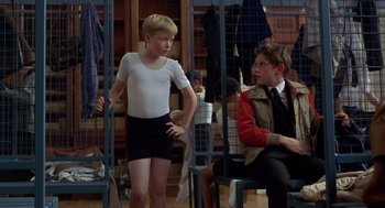 Movie still from “Billy Elliot” (2000), directed by Stephen Daldry – Two young boys are sitting in a room; Medium shot, Over the shoulder angle
